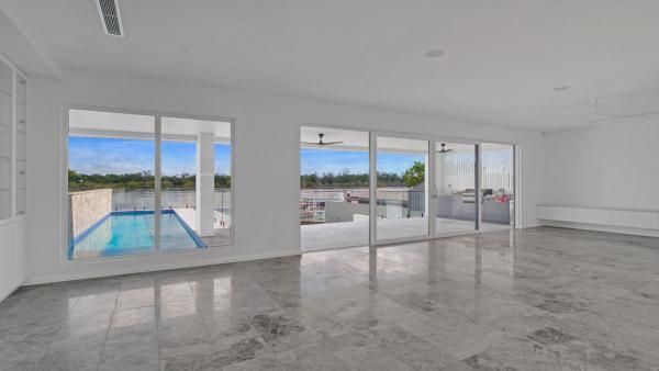 A Large Empty Room with A Swimming Pool in The Background | Mid-North Coast, NSW | BDM Constructions