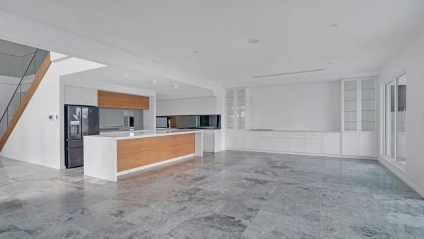 A Large Empty Room with A Kitchen and Stairs | Mid-North Coast, NSW | BDM Constructions