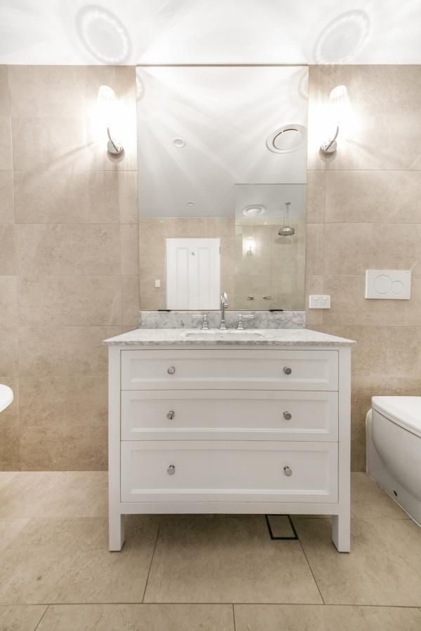 A Bathroom with A Dresser , Sink , Toilet and Mirror | Mid-North Coast, NSW | BDM Constructions