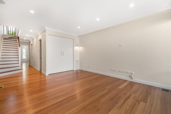 An Empty Living Room with Hardwood Floors and White Walls | Mid-North Coast, NSW | BDM Constructions