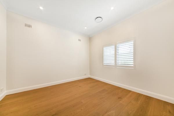 An Empty Room with Hardwood Floors and White Walls | Mid-North Coast, NSW | BDM Constructions