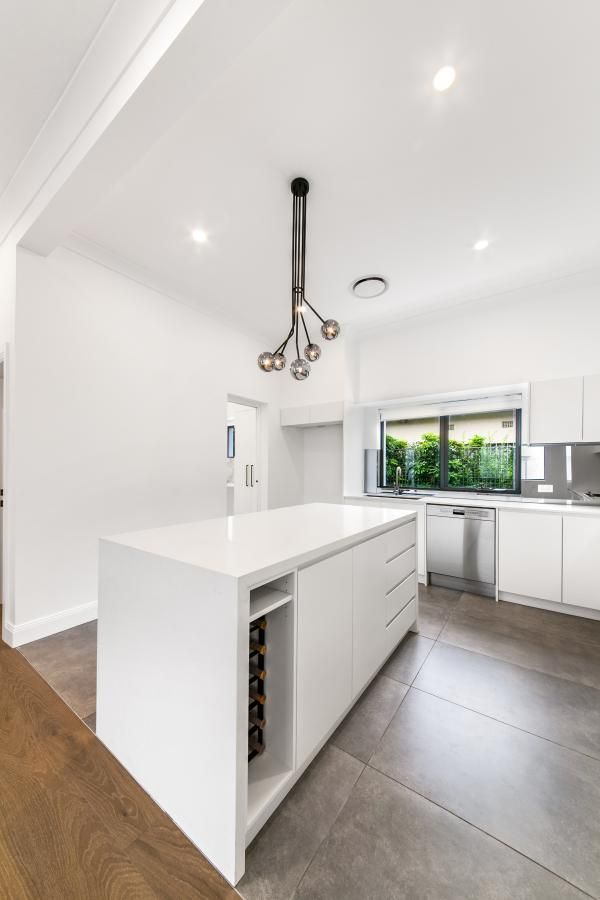 A Kitchen with White Cabinets and A Large Island in The Middle | Mid-North Coast, NSW | BDM Constructions
