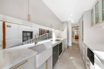 A Long Kitchen with White Cabinets and A Sink | Mid-North Coast, NSW | BDM Constructions