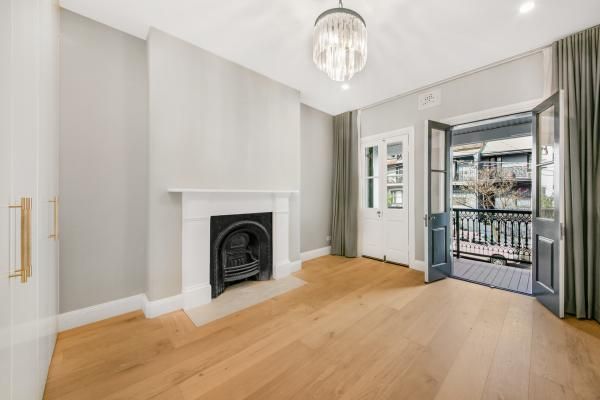 An Empty Living Room with A Fireplace and A Balcony | Mid-North Coast, NSW | BDM Constructions