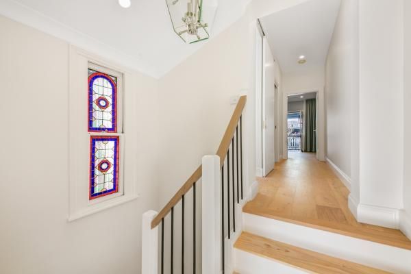 A Hallway with Stairs and A Stained Glass Window | Mid-North Coast, NSW | BDM Constructions