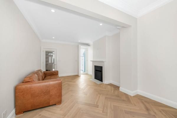 A Living Room with A Brown Couch and A Fireplace | Mid-North Coast, NSW | BDM Constructions