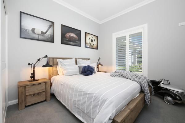A Bedroom with A Bed and A Nightstand | Mid-North Coast, NSW | BDM Constructions