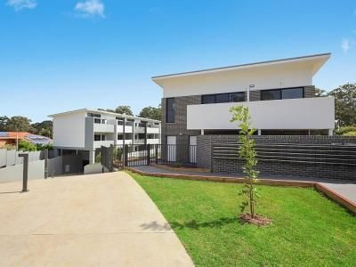 A Large White House with A Brick Fence and A Lush Green Lawn in Front of It | Mid-North Coast, NSW | BDM Constructions