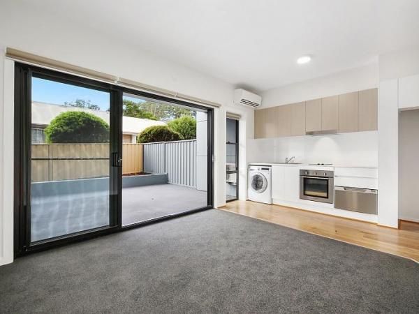 A Living Room with A Sliding Glass Door that Leads to A Kitchen | Mid-North Coast, NSW | BDM Constructions