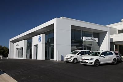 Two White Cars Are Parked in Front of A Volkswagen Dealership | Mid-North Coast, NSW | BDM Constructions