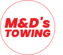 Red text "M&D's TOWING" in a red circle on a white background.
