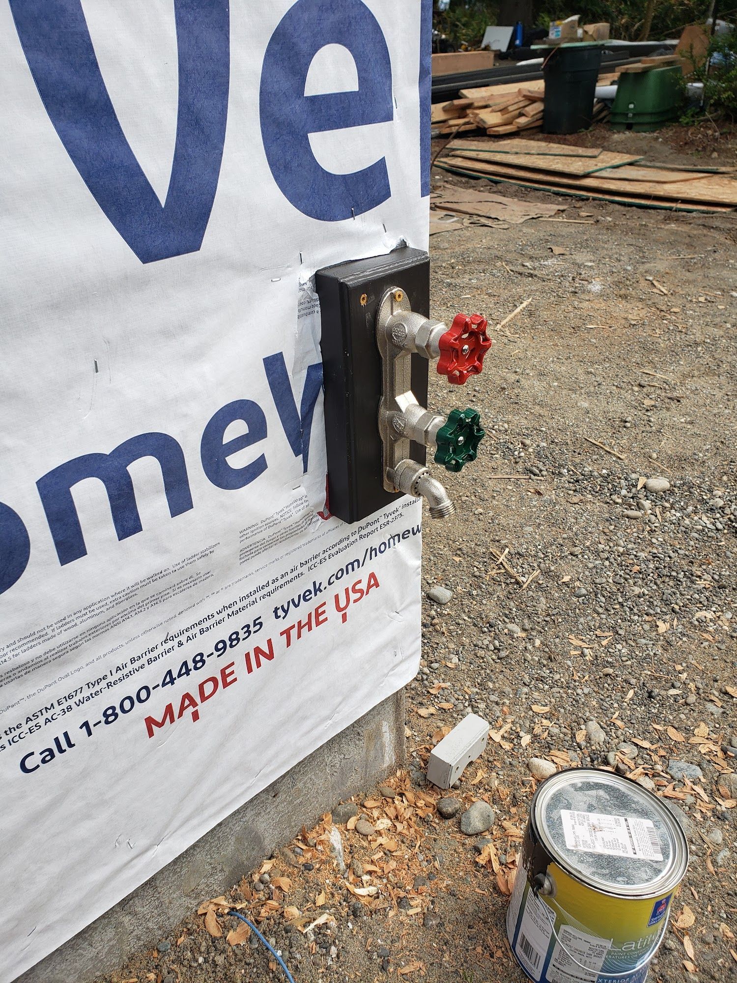 Red and green electrical buttons mounted on a white banner at a construction site