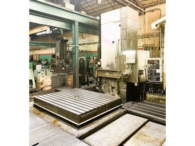 Large industrial milling machine in a factory setting.
