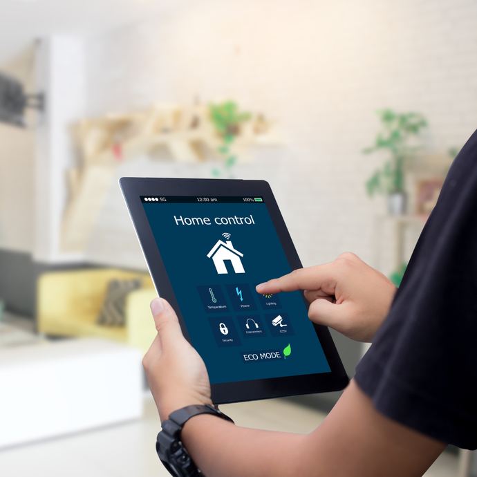 A person is holding a tablet that says home control on it