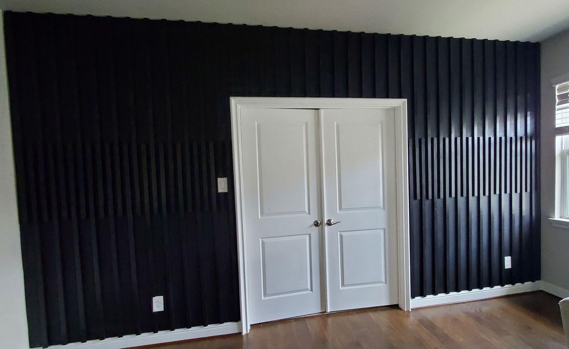 An empty garage with blue walls and a gray floor.