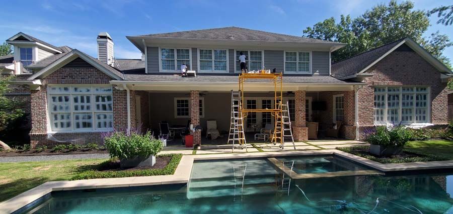 A large house with a swimming pool in front of it.