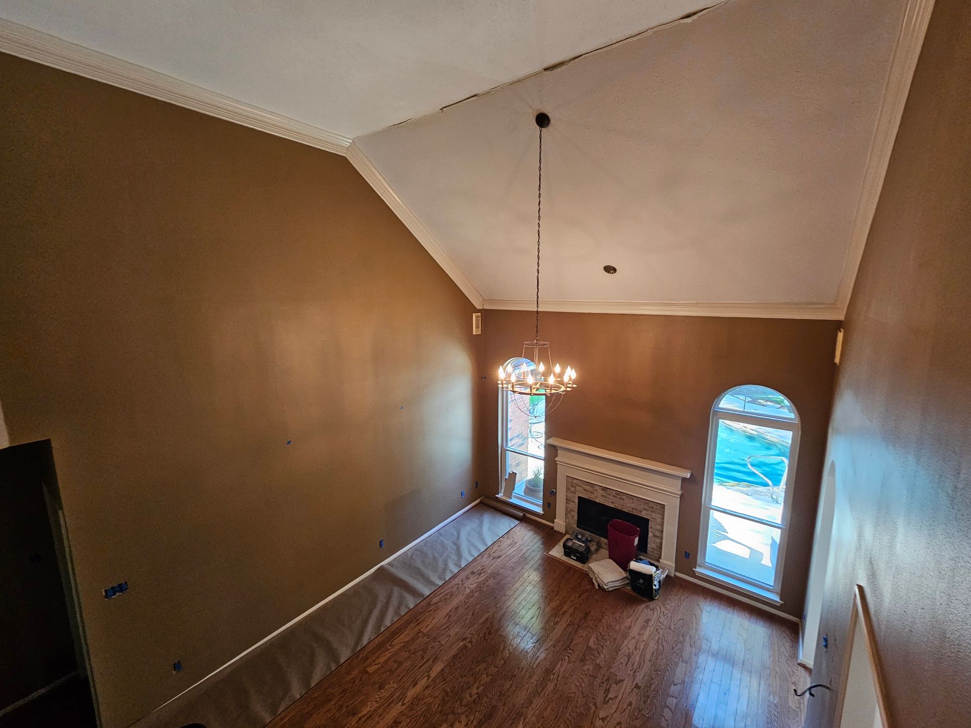 An empty room with green walls and a window.