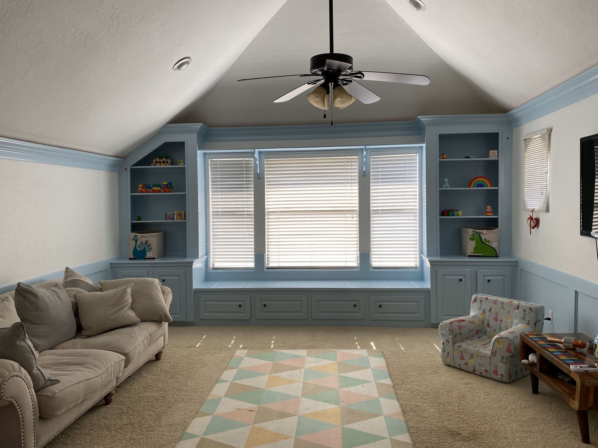A living room with a ceiling fan and a couch