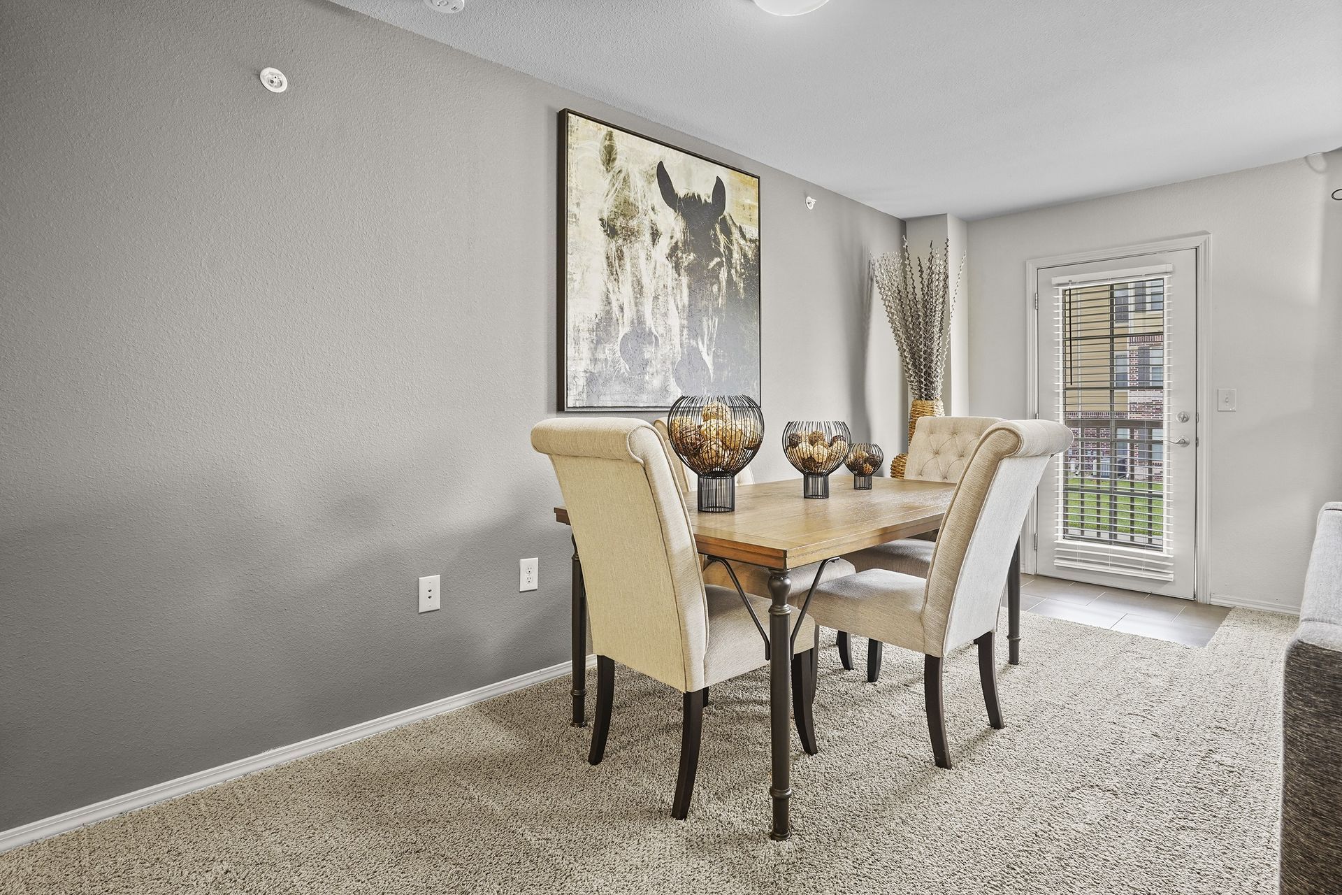 A dining room with a table and chairs.