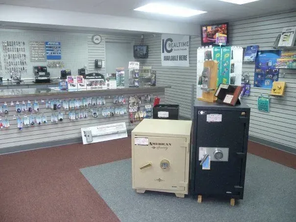 A small store interior with various safes displayed on the floor. 