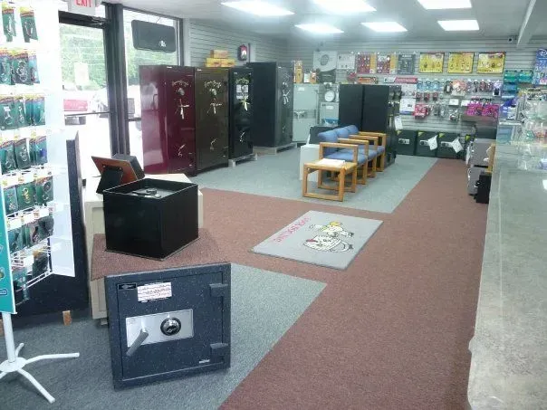 Well-lit store interior with various safes displayed. 