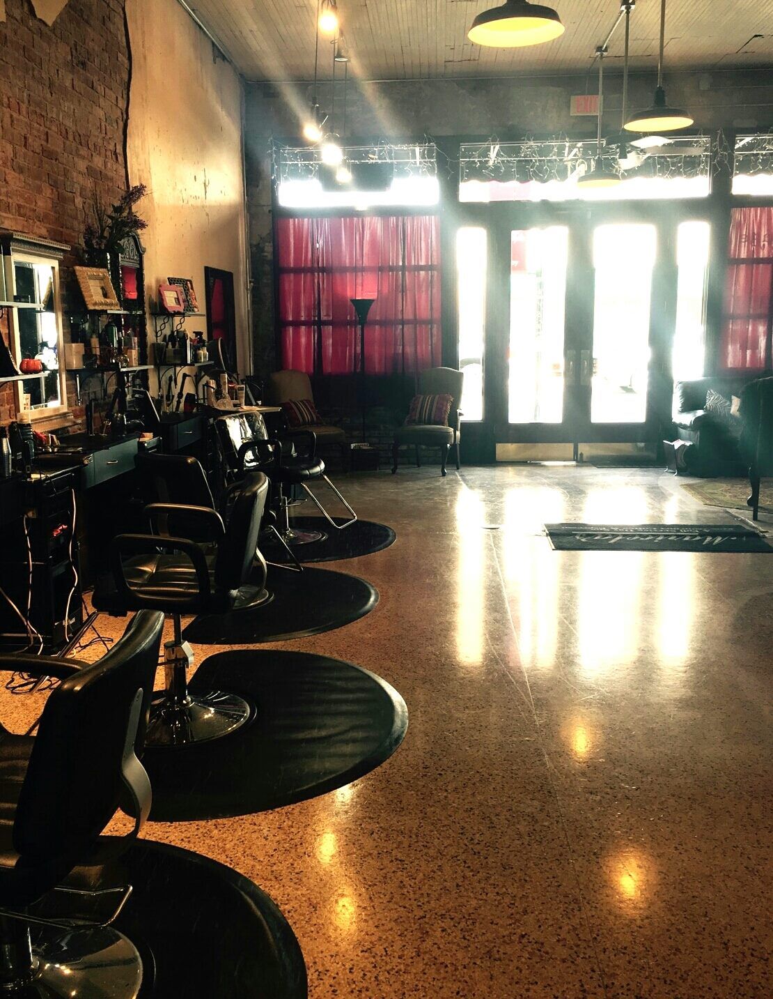 A barber shop with a lot of chairs and tables