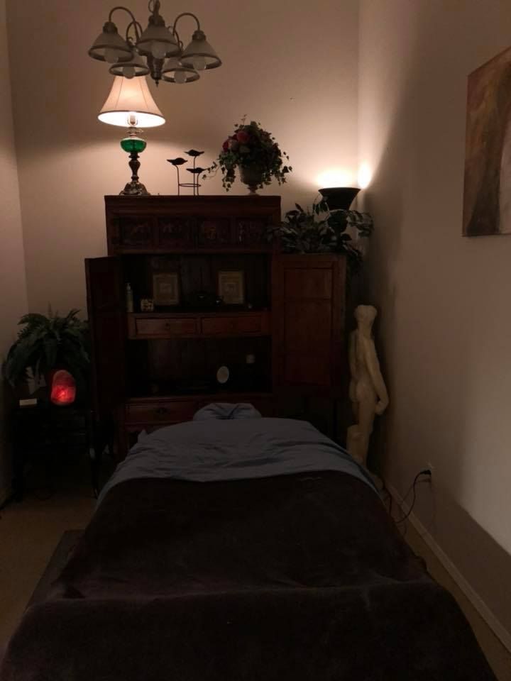 There is a massage table in the middle of the room.