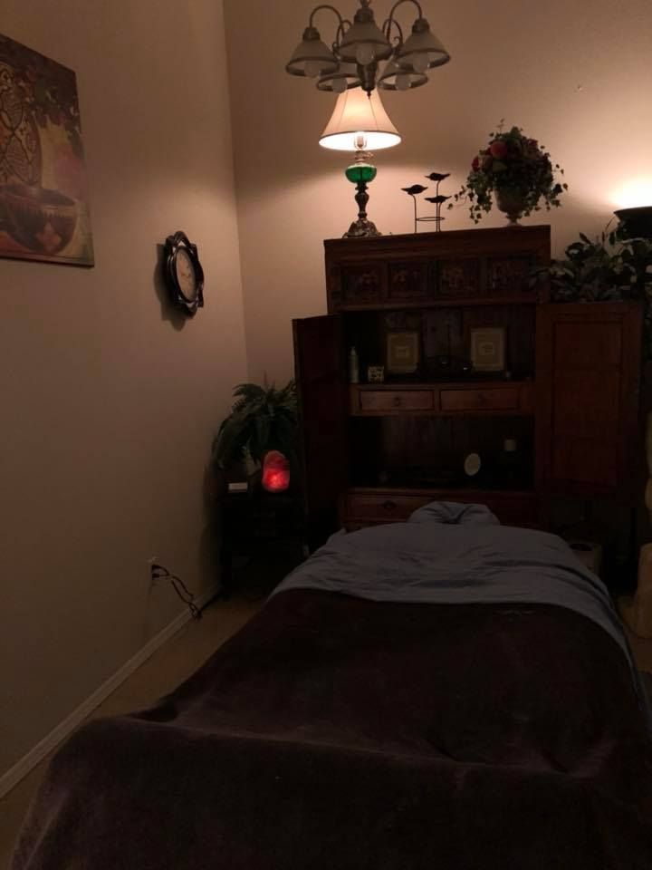 A dark room with a bed and a lamp