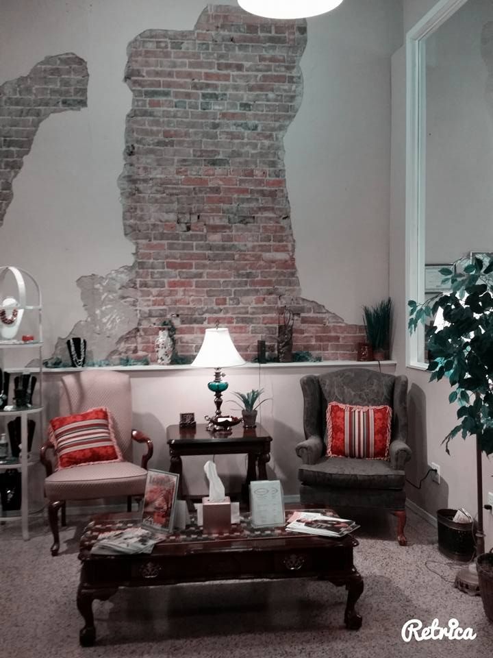 A living room with a brick wall and a coffee table