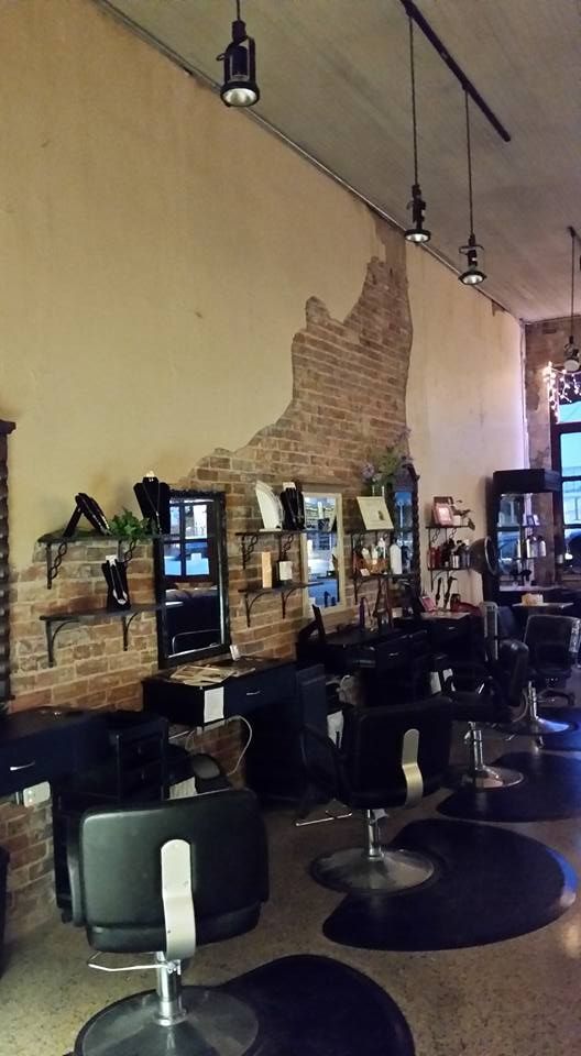 A hair salon with a lot of chairs and mirrors.