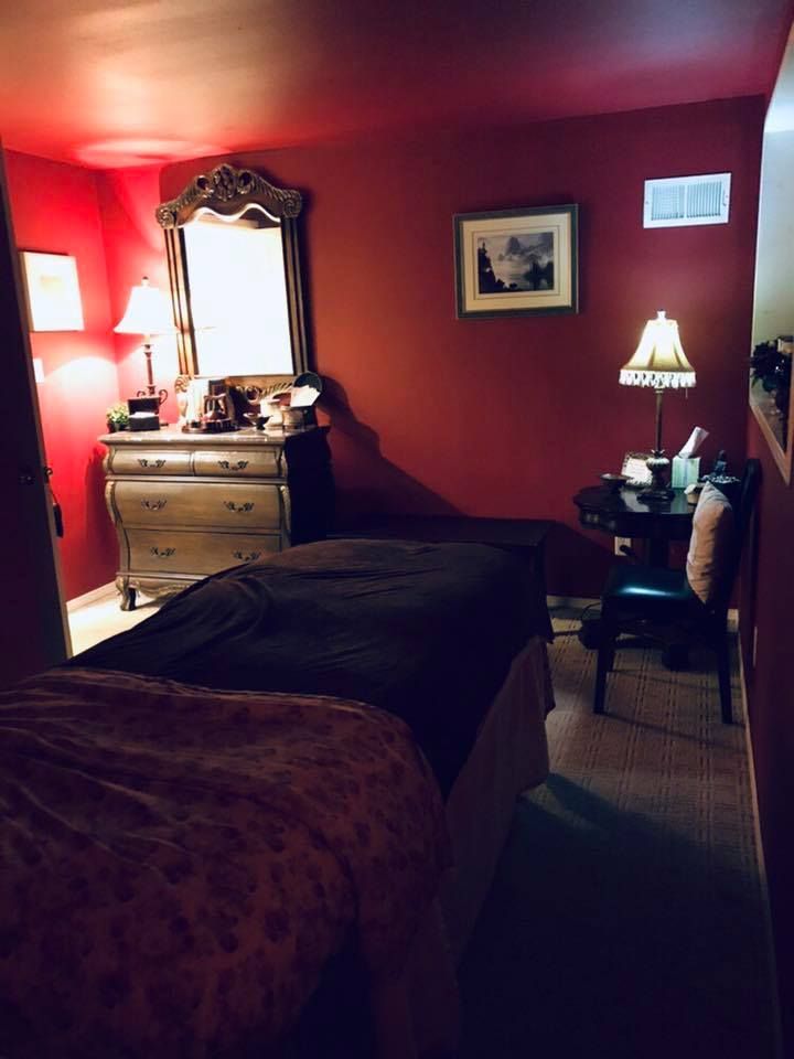 A bedroom with red walls and two beds