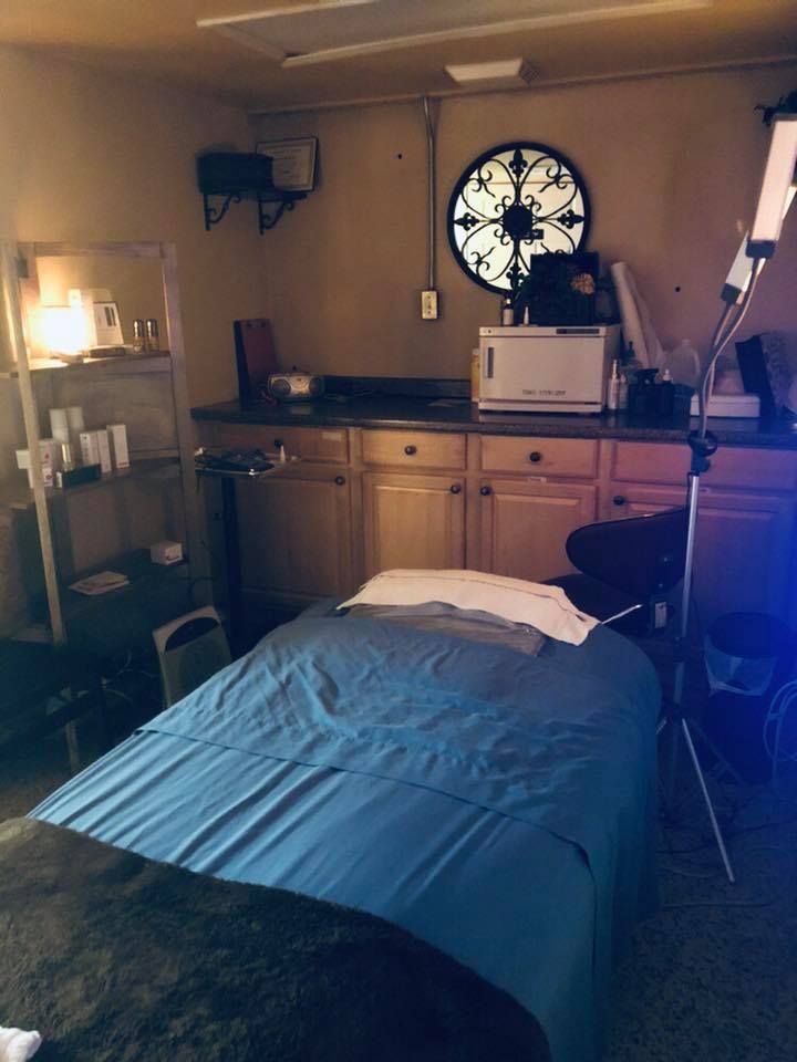 A massage table in a room with a blue blanket
