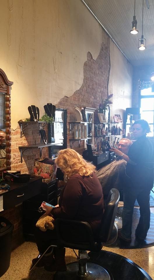 A woman is getting her hair cut in a salon.