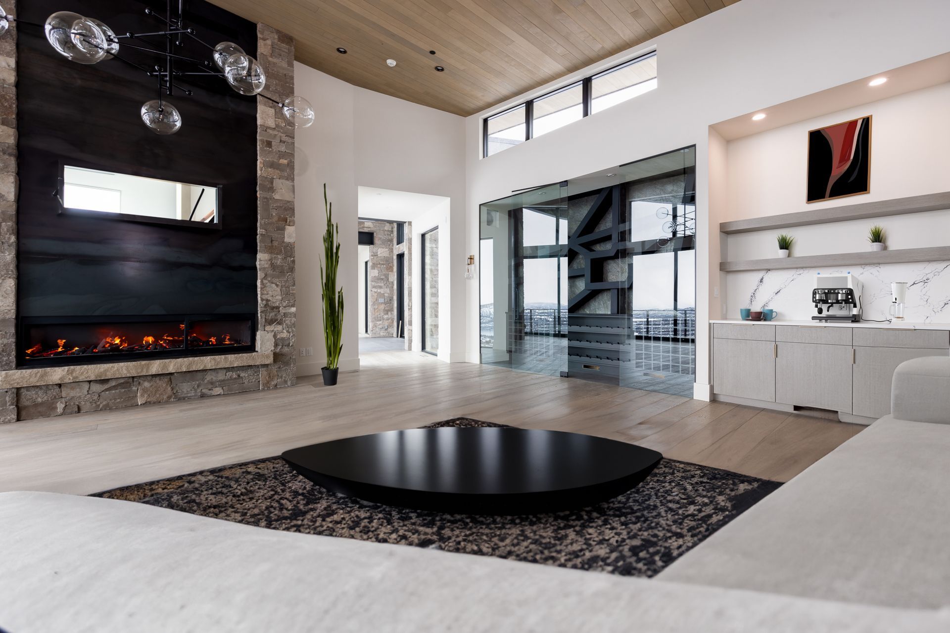 A living room with a fireplace and a black coffee table