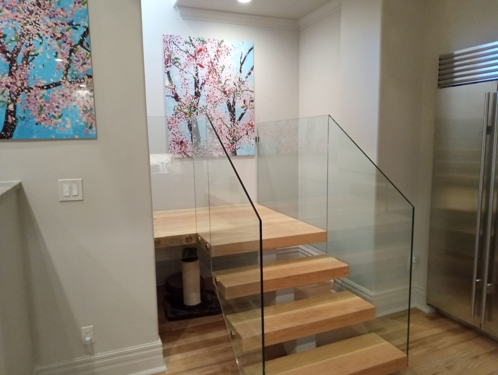 a room with hardwood floors and sliding glass doors installed by Sun Glass