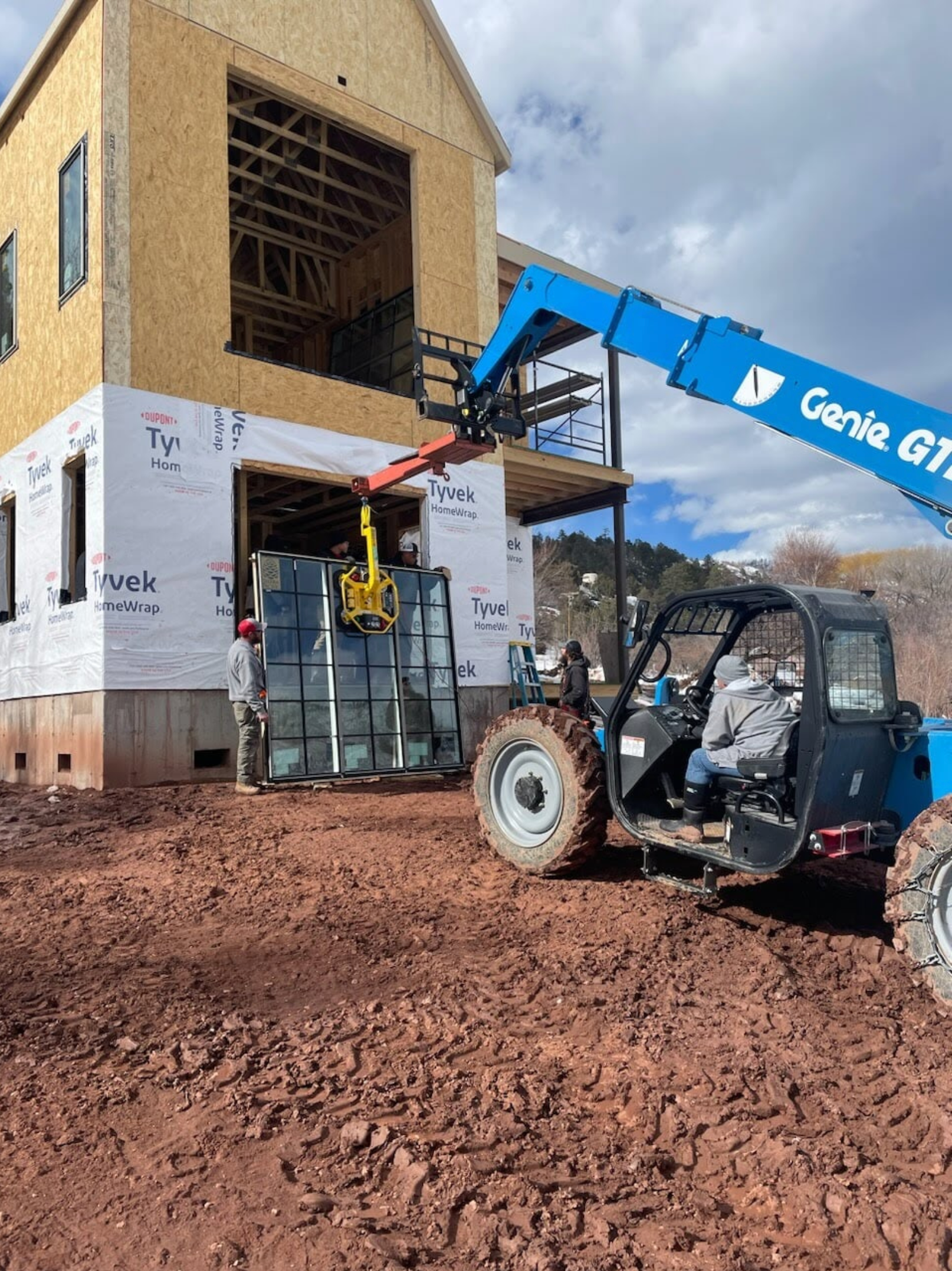 a Sun Glass truck is parked in front of a building under construction
