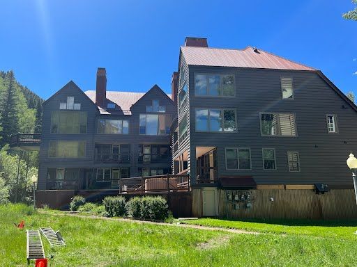 a large house with a red roof is with lots of windows installed by Sun Glass .