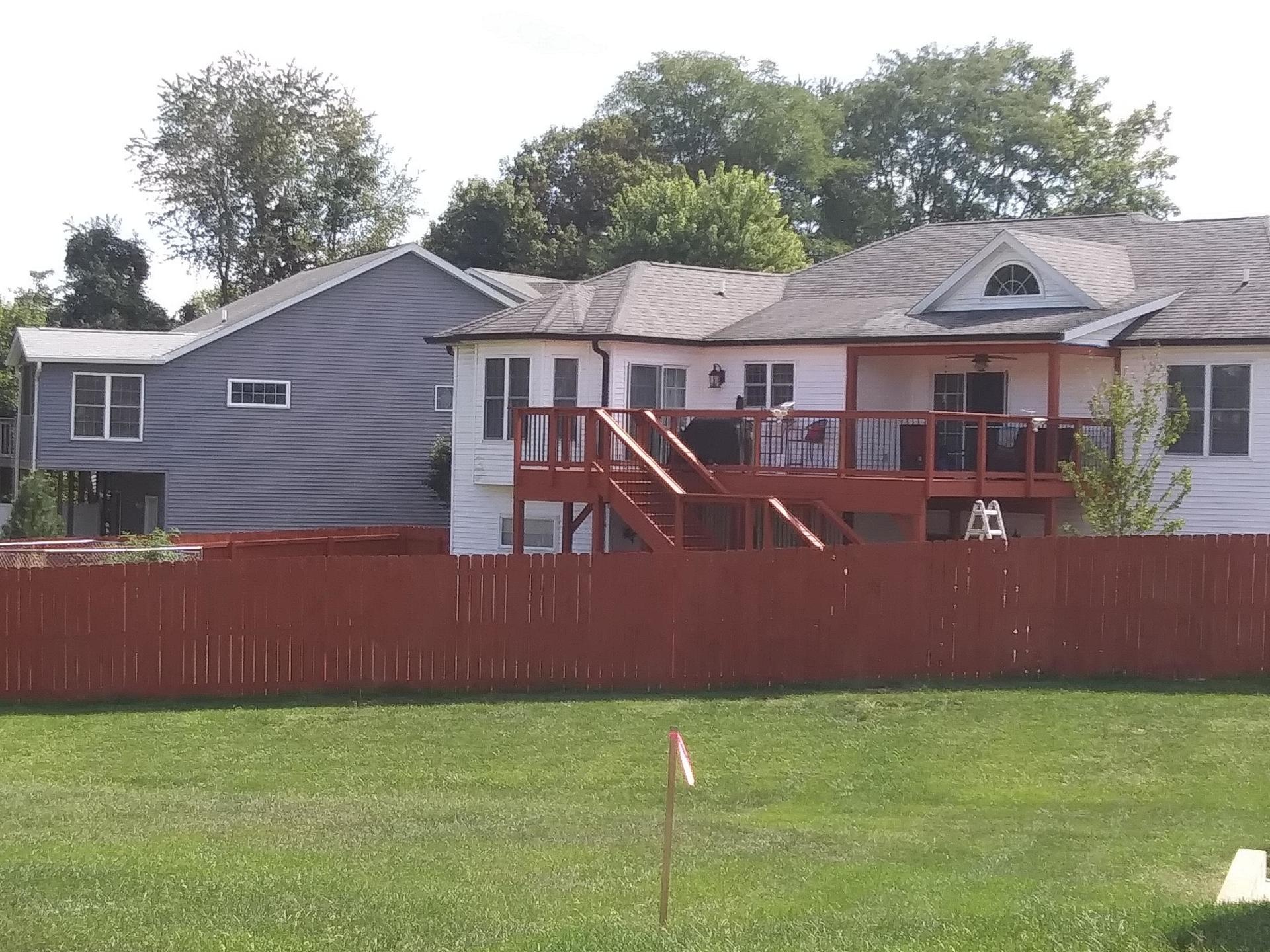 A house with a red fence in front of it