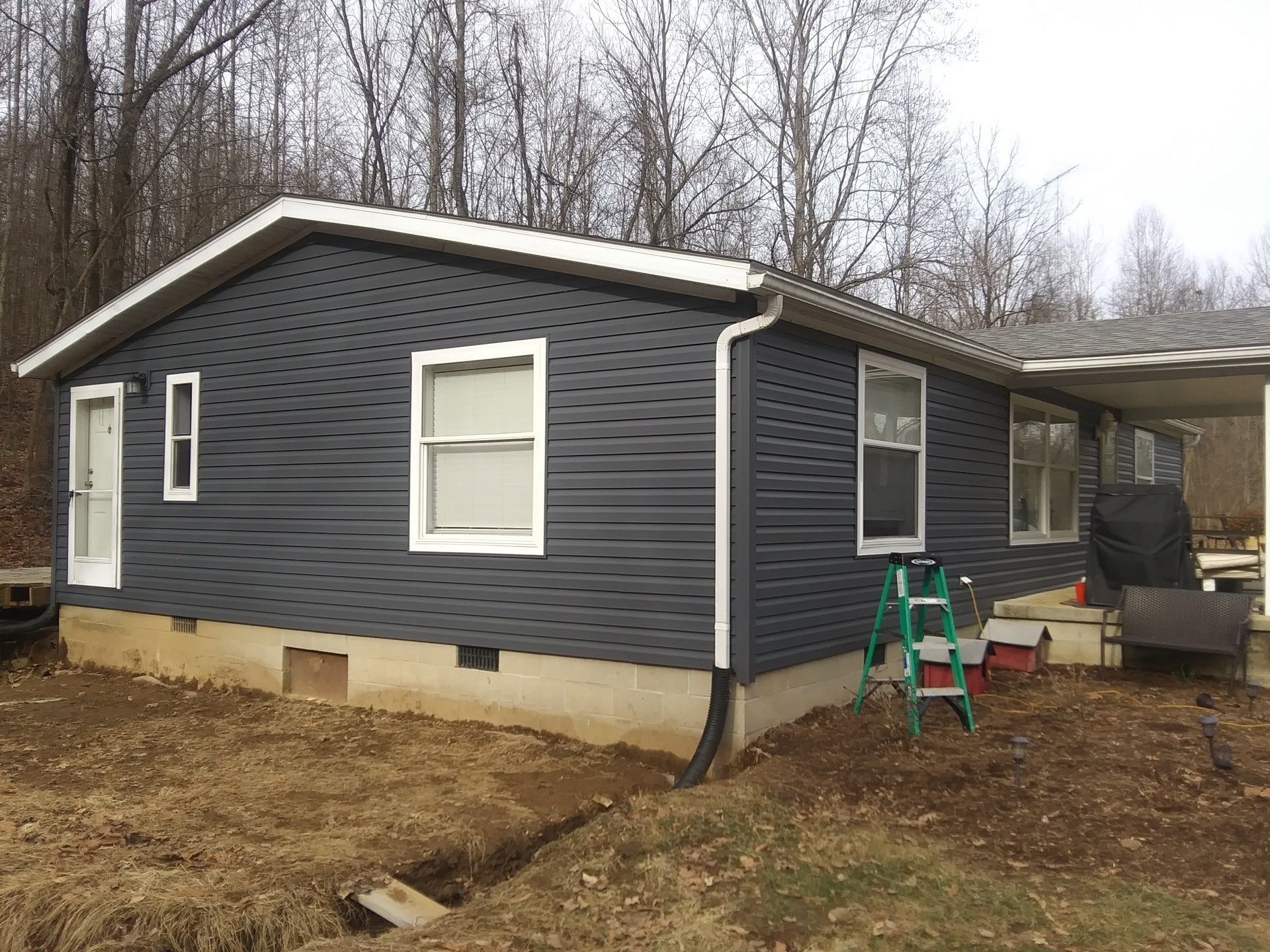 A small house with a ladder in front of it.