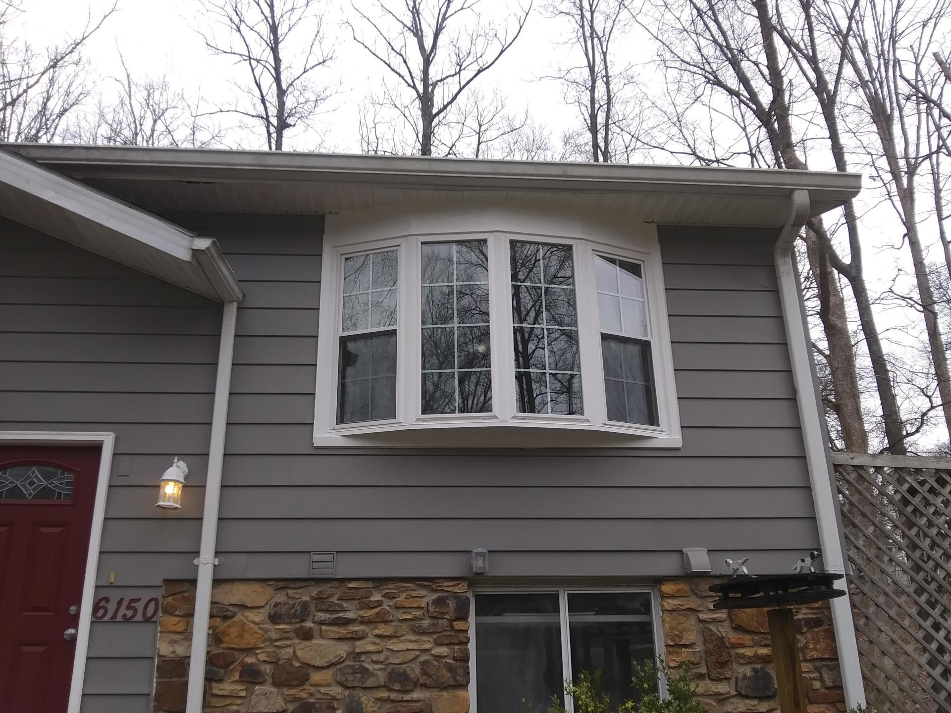 A house with a large window and a red door