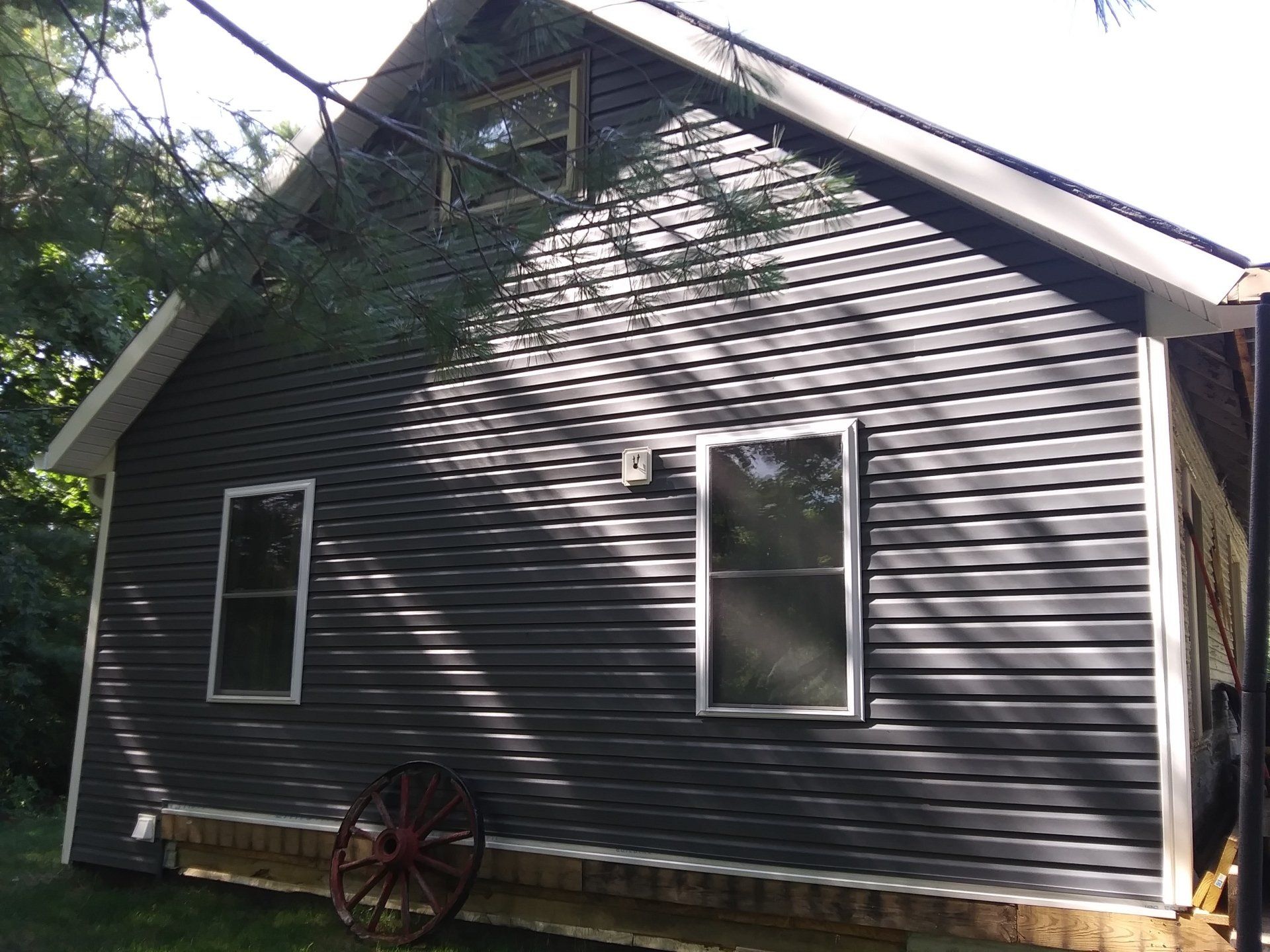 A house with a wagon wheel in front of it