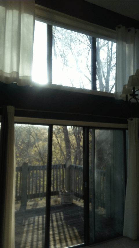 A living room with a sliding glass door leading to a deck
