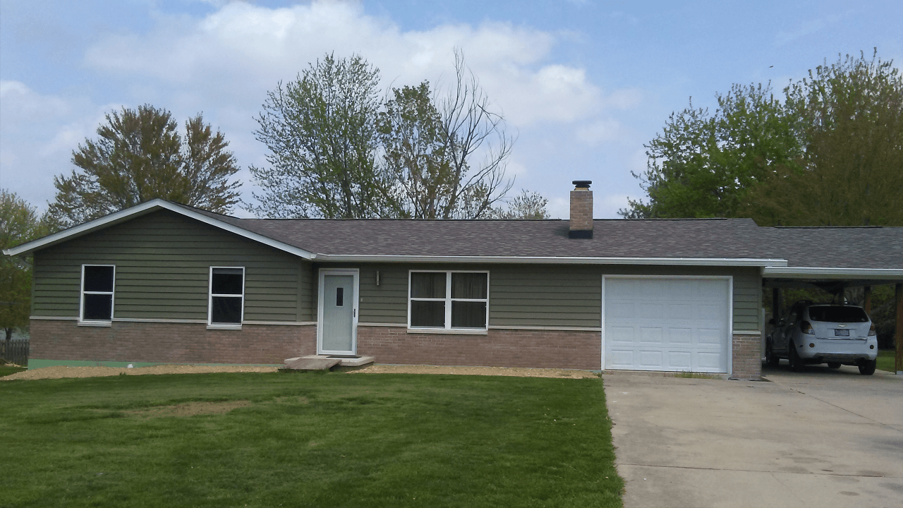 A house with a car parked in front of it