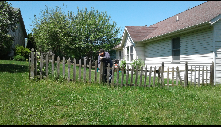 A wooden picket fence in front of a house