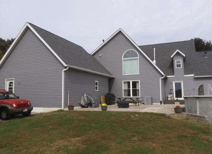 A large house with a red truck parked in front of it