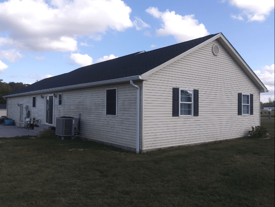 A white house with a black roof and black shutters