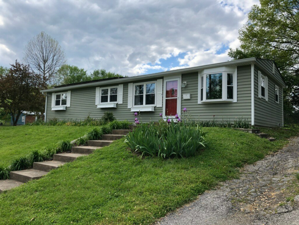 A house with a lot of windows and stairs leading up to it