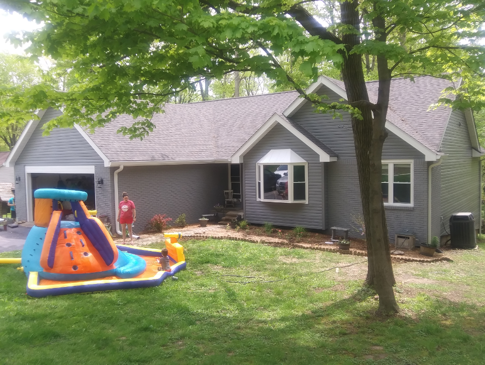 A house with a water slide in front of it