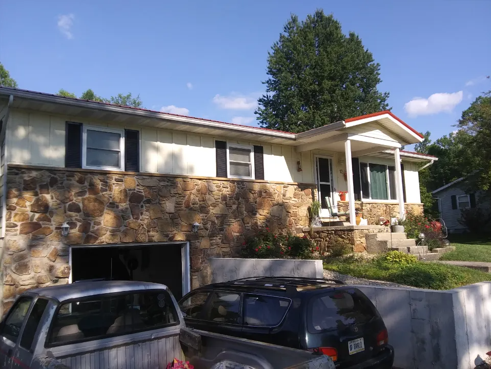 A house with a car parked in front of it
