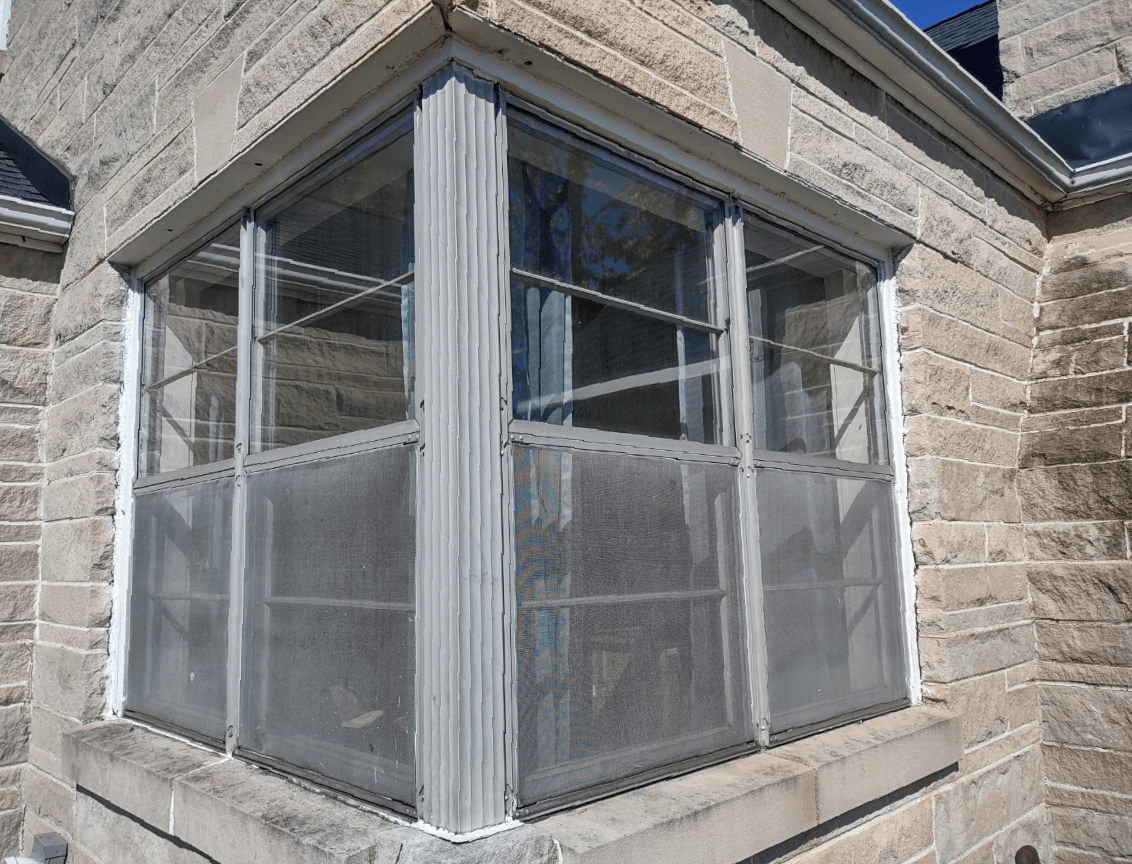 A large window on the side of a brick building.